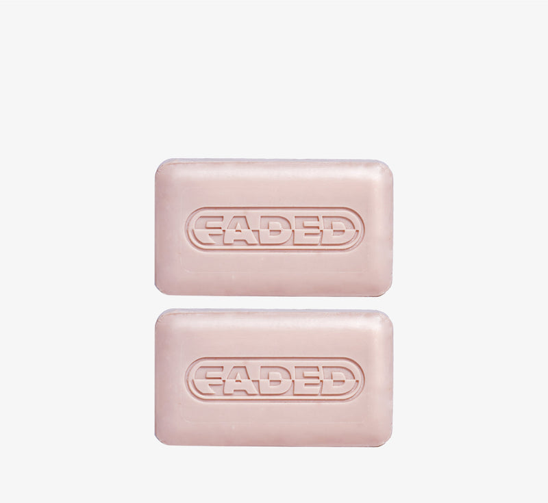 Brightening cleansing bars from Topicals Faded shown as two pink embossed bars stacked on a white background.