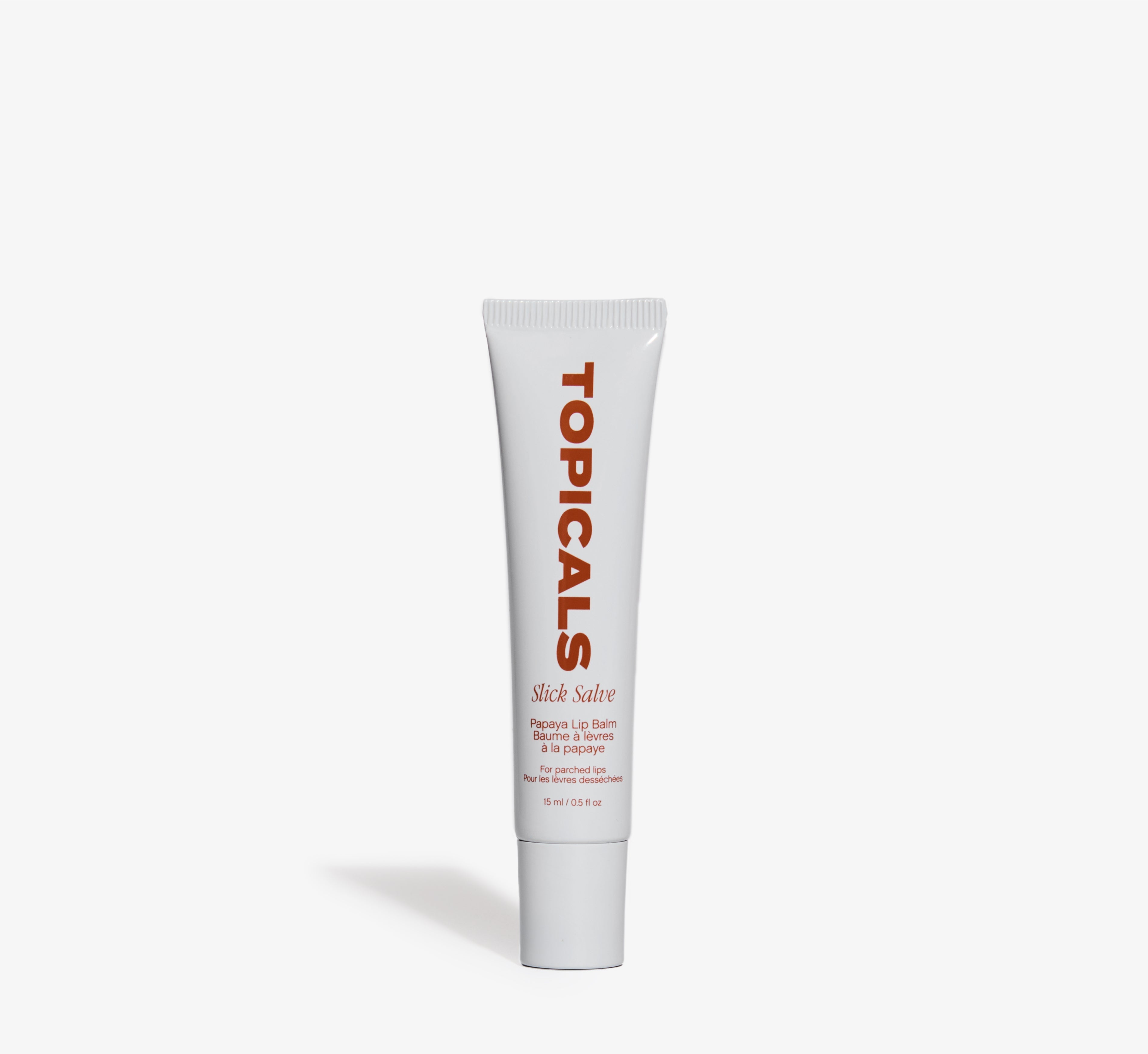 Papaya lip balm from Topicals Slick Salve shown as a single white 15ml squeeze tube on a white background.