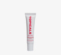 Moisturizing lip balm from Topicals Slick Salve in Pomegranate shown as a single white tube standing upright on a white background.