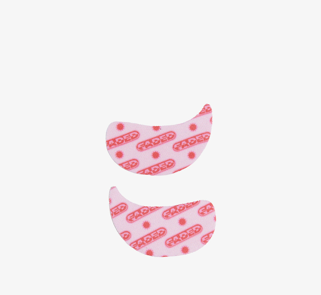 Hydrogel eye patches from Topicals Faded shown as a left and right pair in the pink branded colorway on a white background.